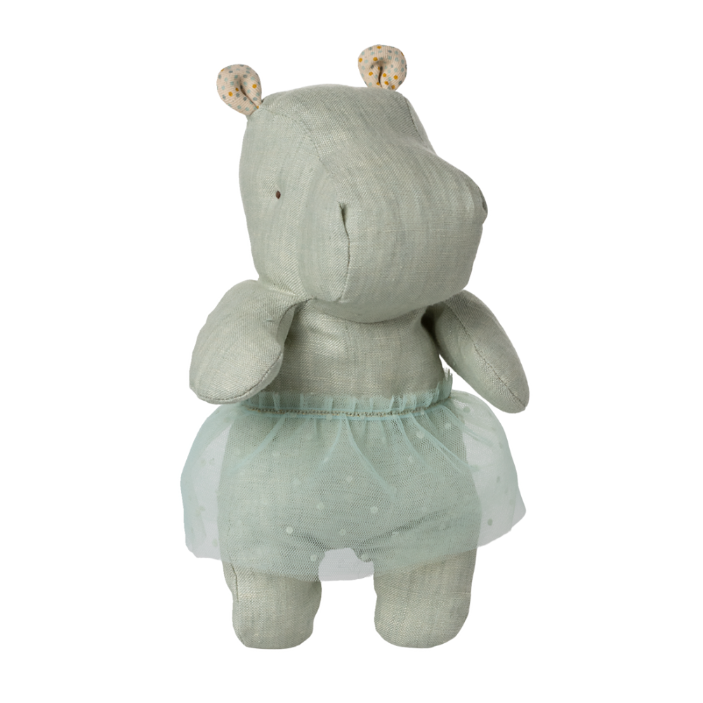 Mint green fabric hippo toy wearing tulle skirt against white striped background