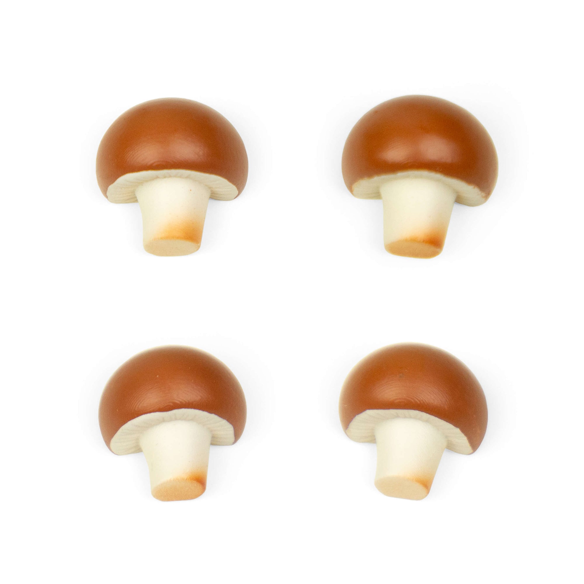 Four brown mushroom-shaped magnets with white stems arranged in a 2x2 grid on white background