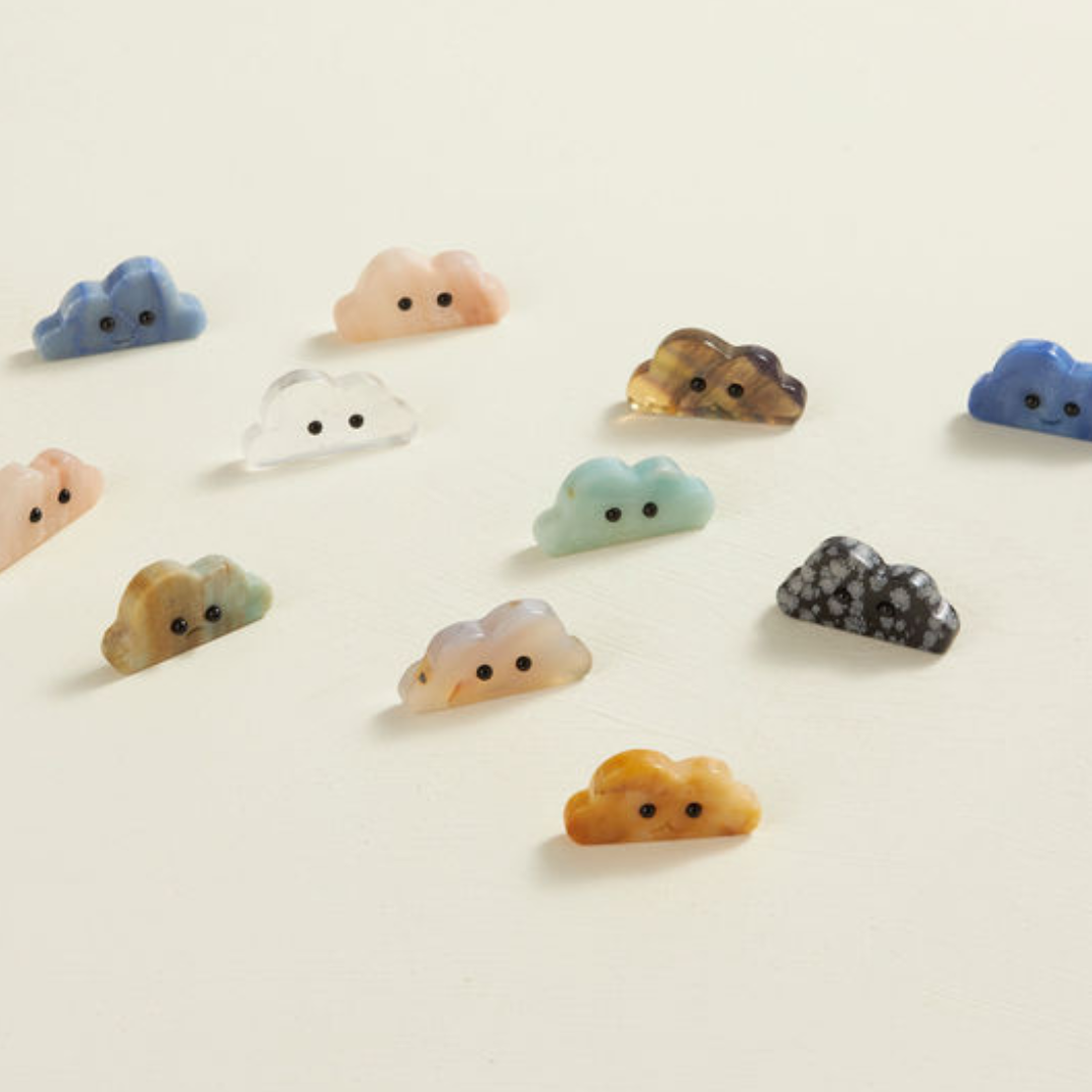 Assorted crystal cloud-shaped figurines with cute faces in various colors and stone types