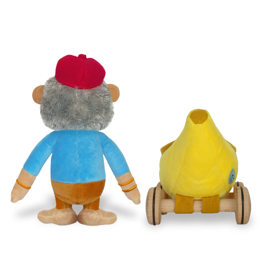 Yottoy plush gorilla toy wearing red cap and blue shirt beside yellow banana-shaped vehicle on wooden wheels
