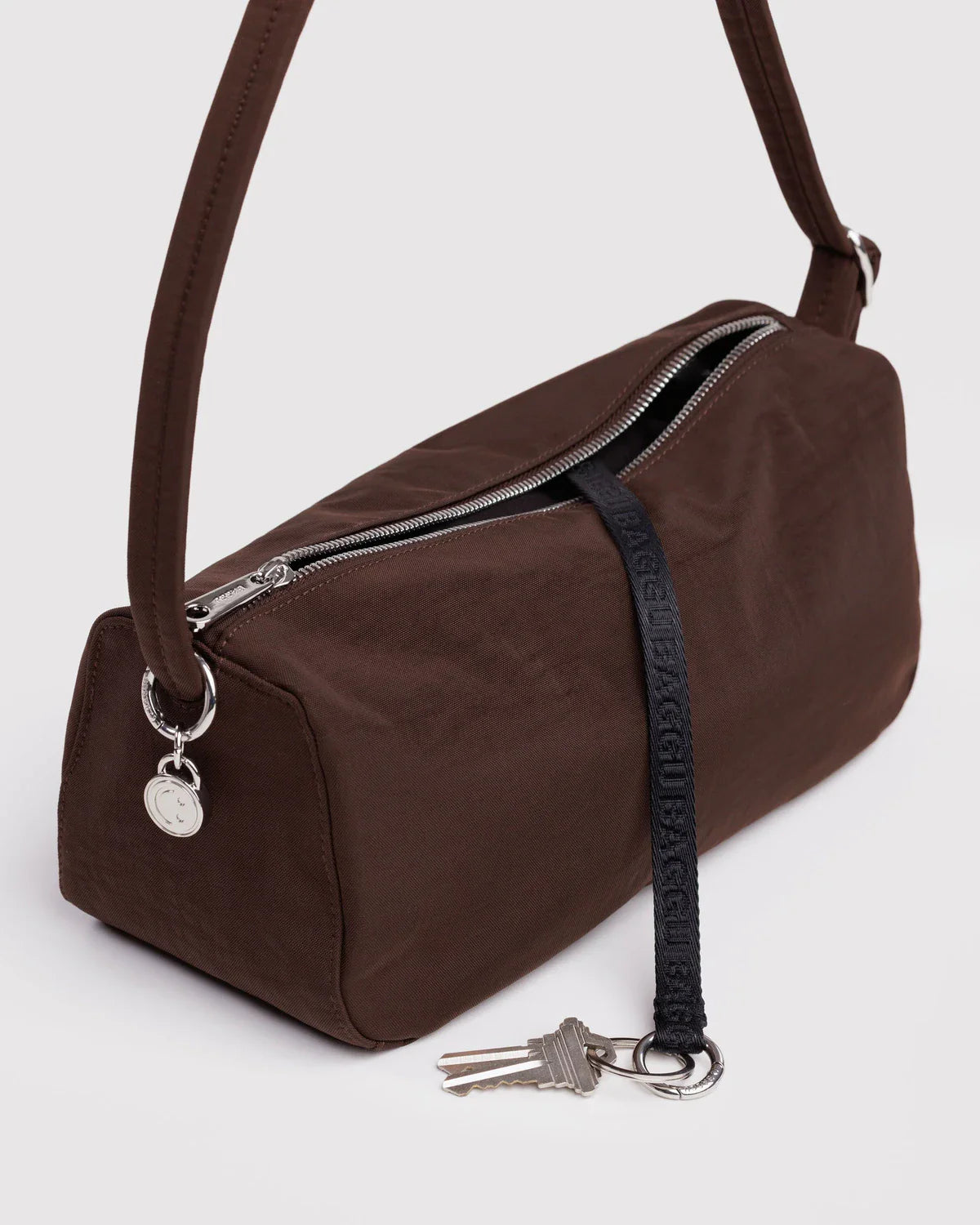 Baggu Nylon Loaf Bag in coffee brown with silver zipper, shoulder strap, and attached key lanyard
