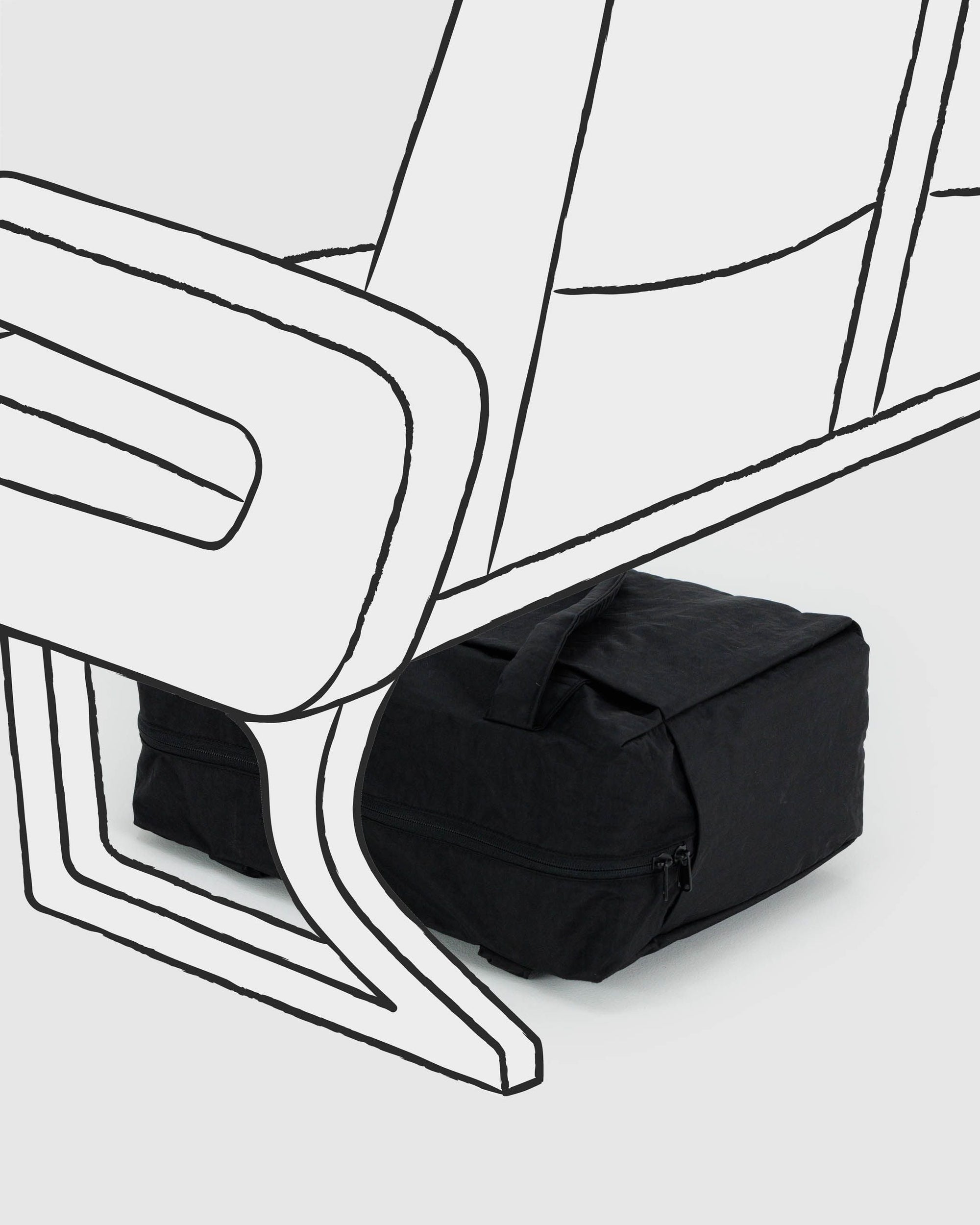 Black carry-on bag with minimal line art illustration of chair and luggage