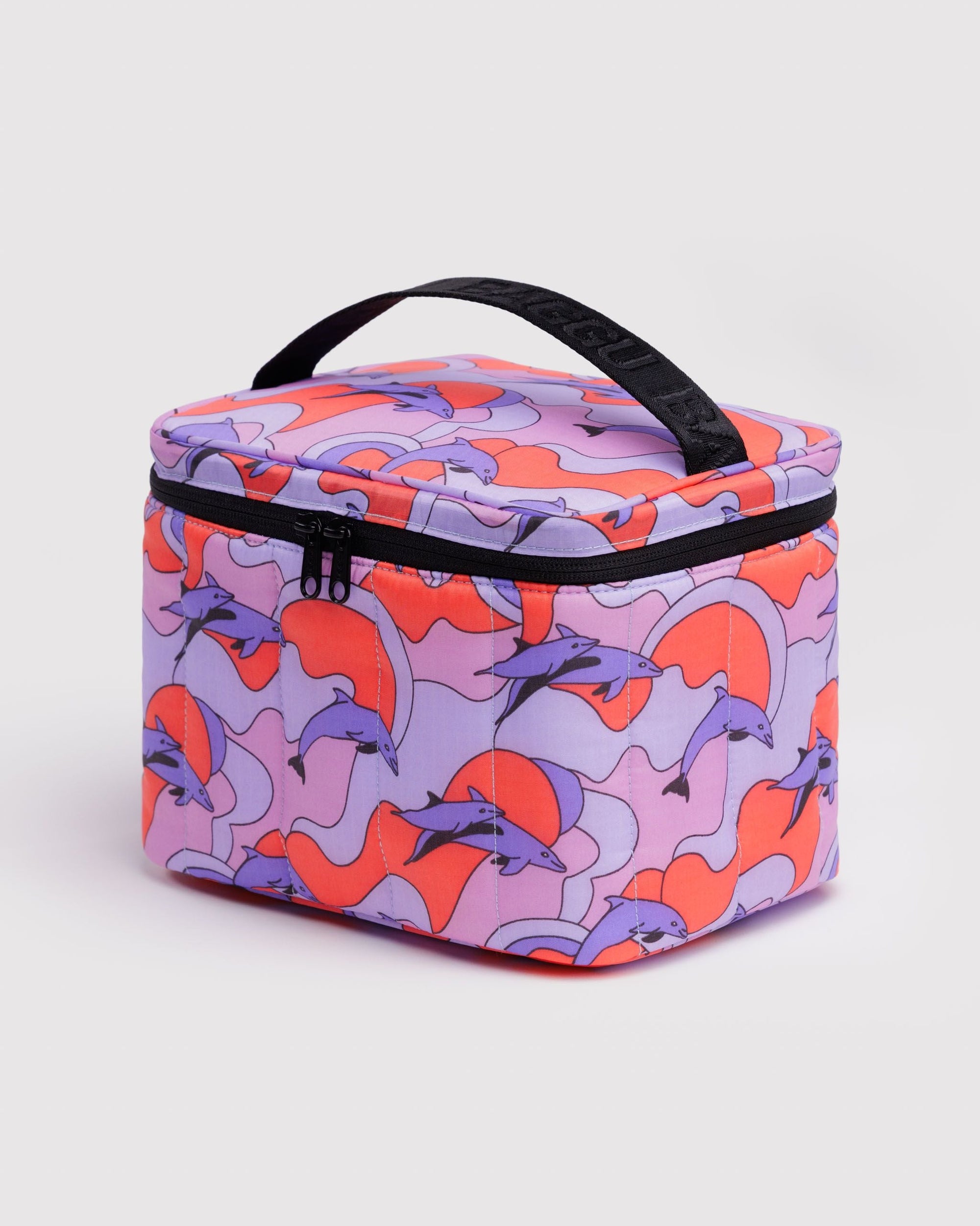 Baggu Puffy Lunch Bag in Dolphins print featuring purple dolphins on coral and lavender wavy background with black zipper ...