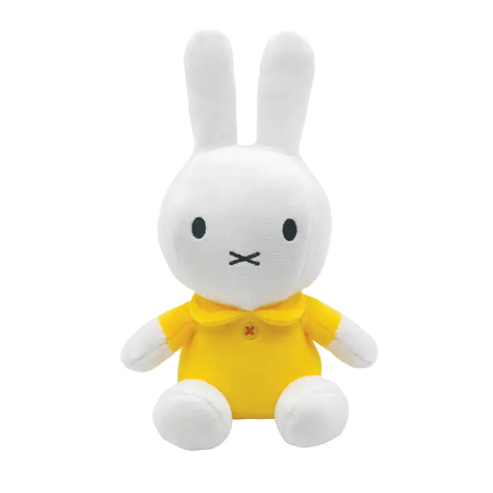 Miffy white plush bunny beanbag doll wearing bright yellow dress, sitting upright
