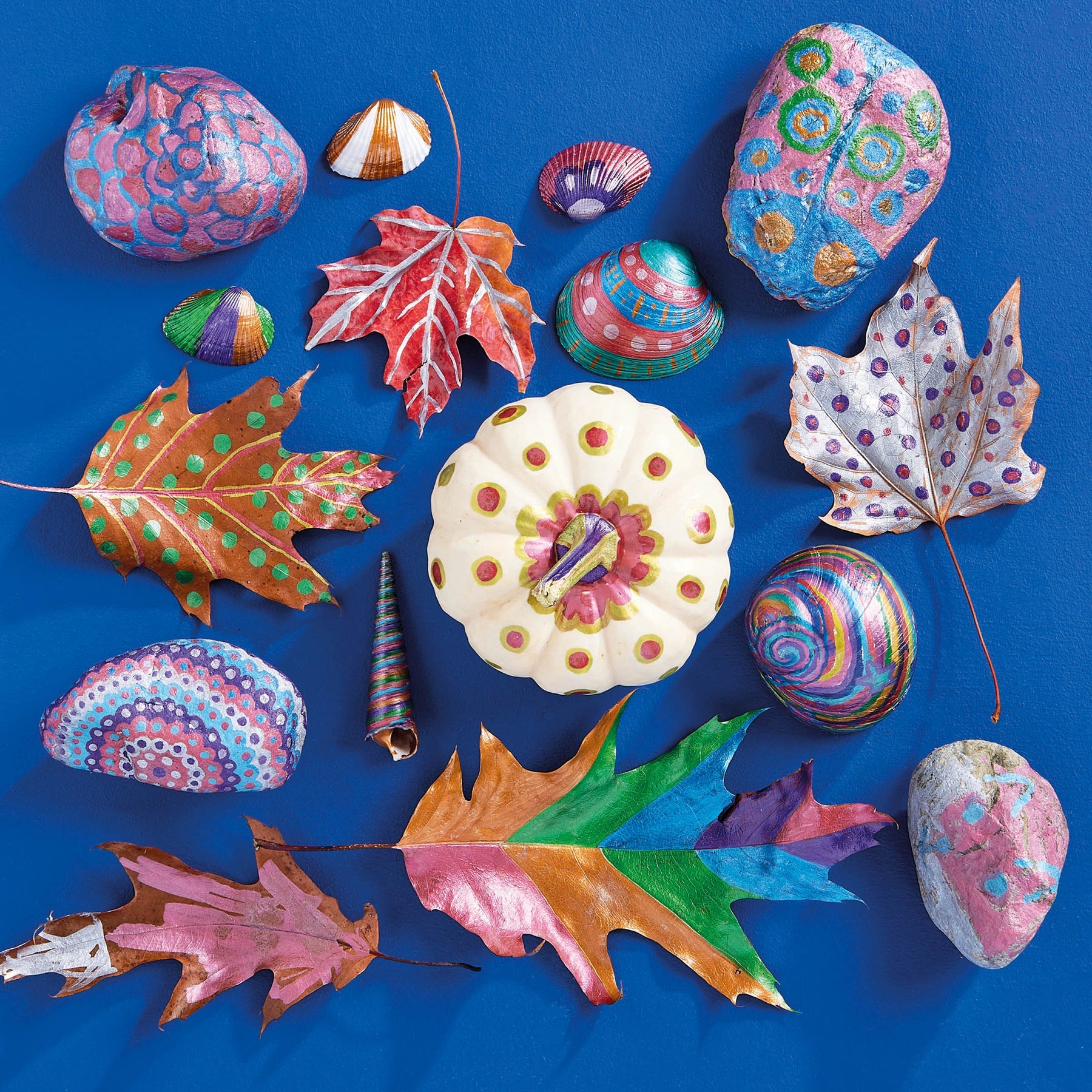 Colorful painted rocks and leaves on a blue background