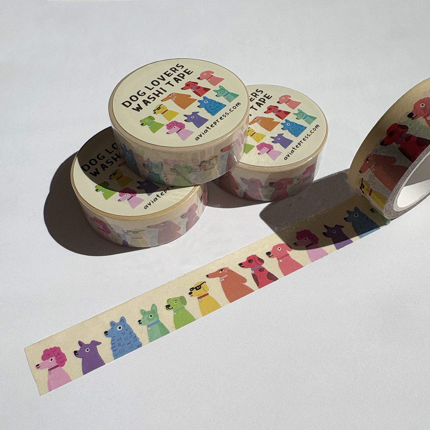 Colorful dog lovers washi tape rolls and unrolled tape showing rainbow dogs by Aviate Press