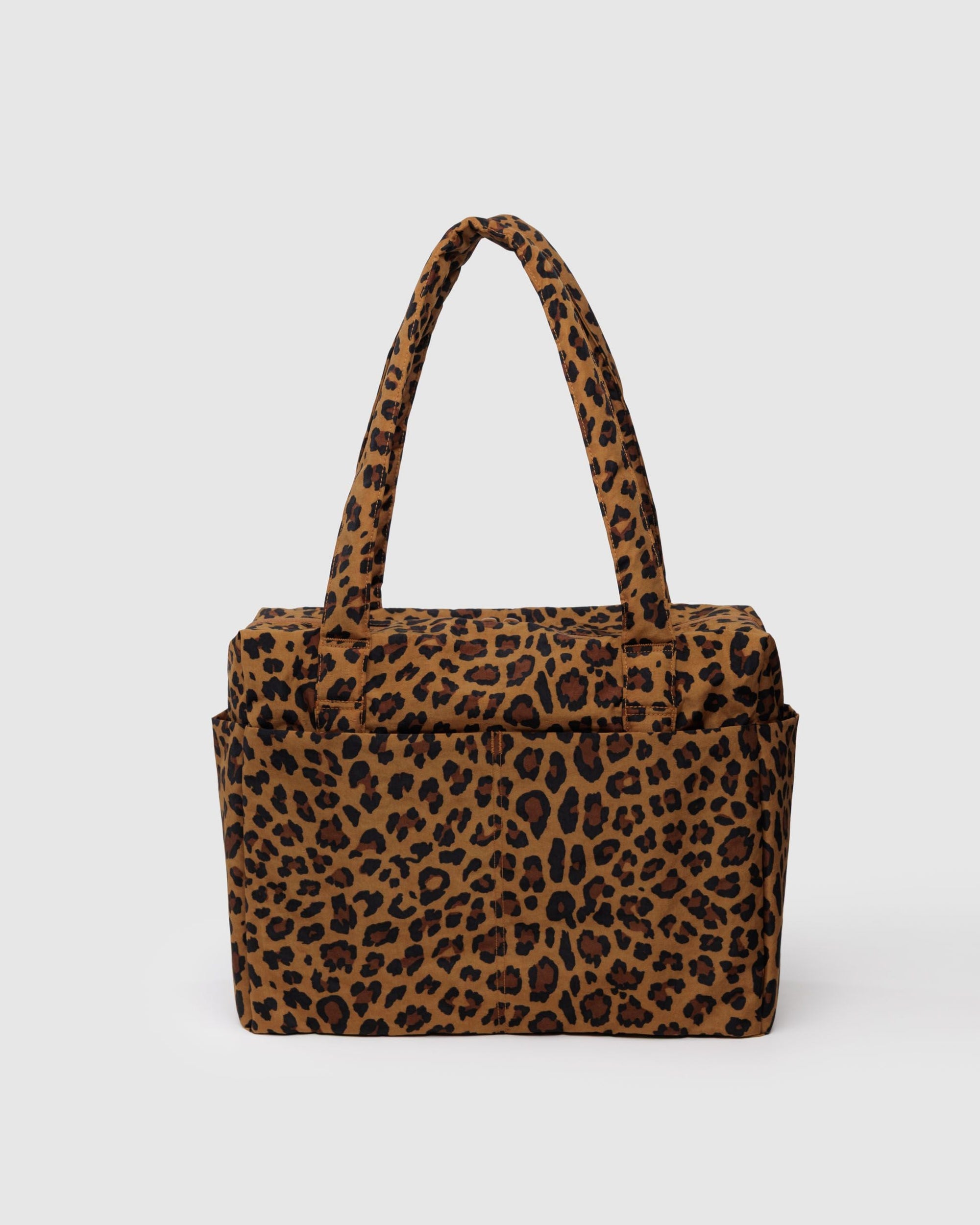Leopard print tote bag with handles and front pocket on gray background