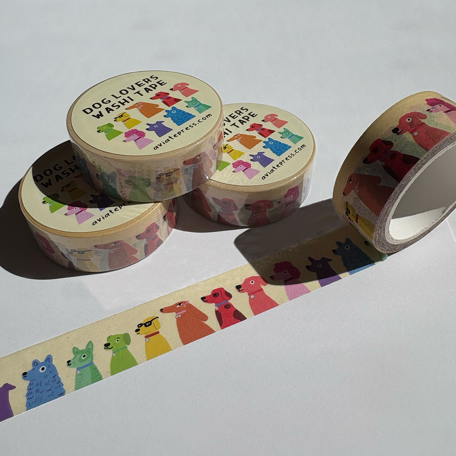 Four rolls of colorful dog lovers washi tape with rainbow dogs pattern by Aviate Press