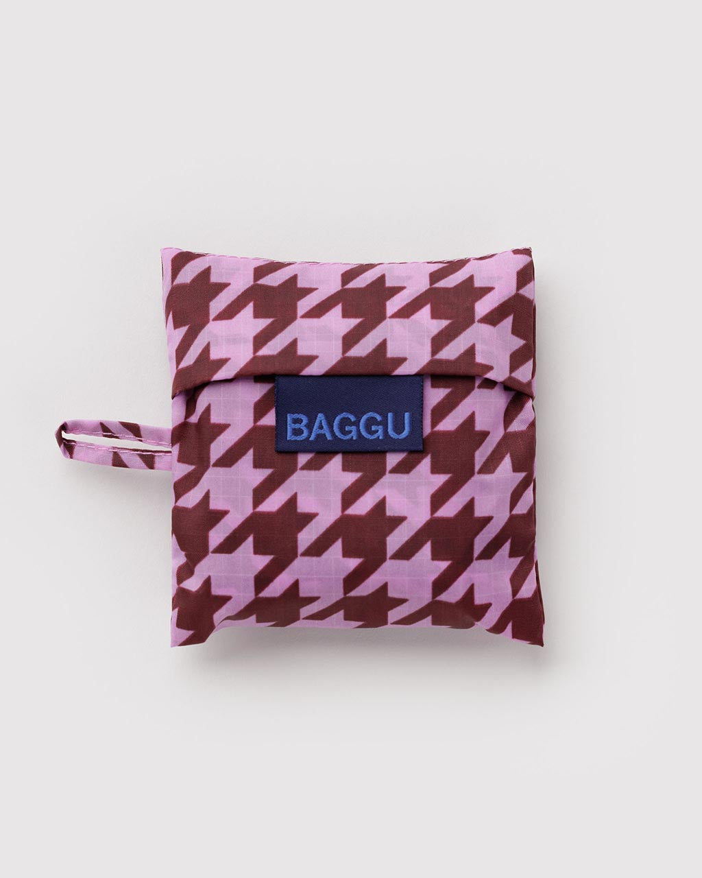 Baby Baggu reusable bag folded into pouch with pink and maroon houndstooth pattern