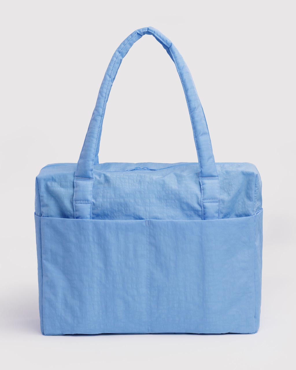 Baggu Cloud Carry-on tote bag in light cornflower blue with padded handles and exterior pockets