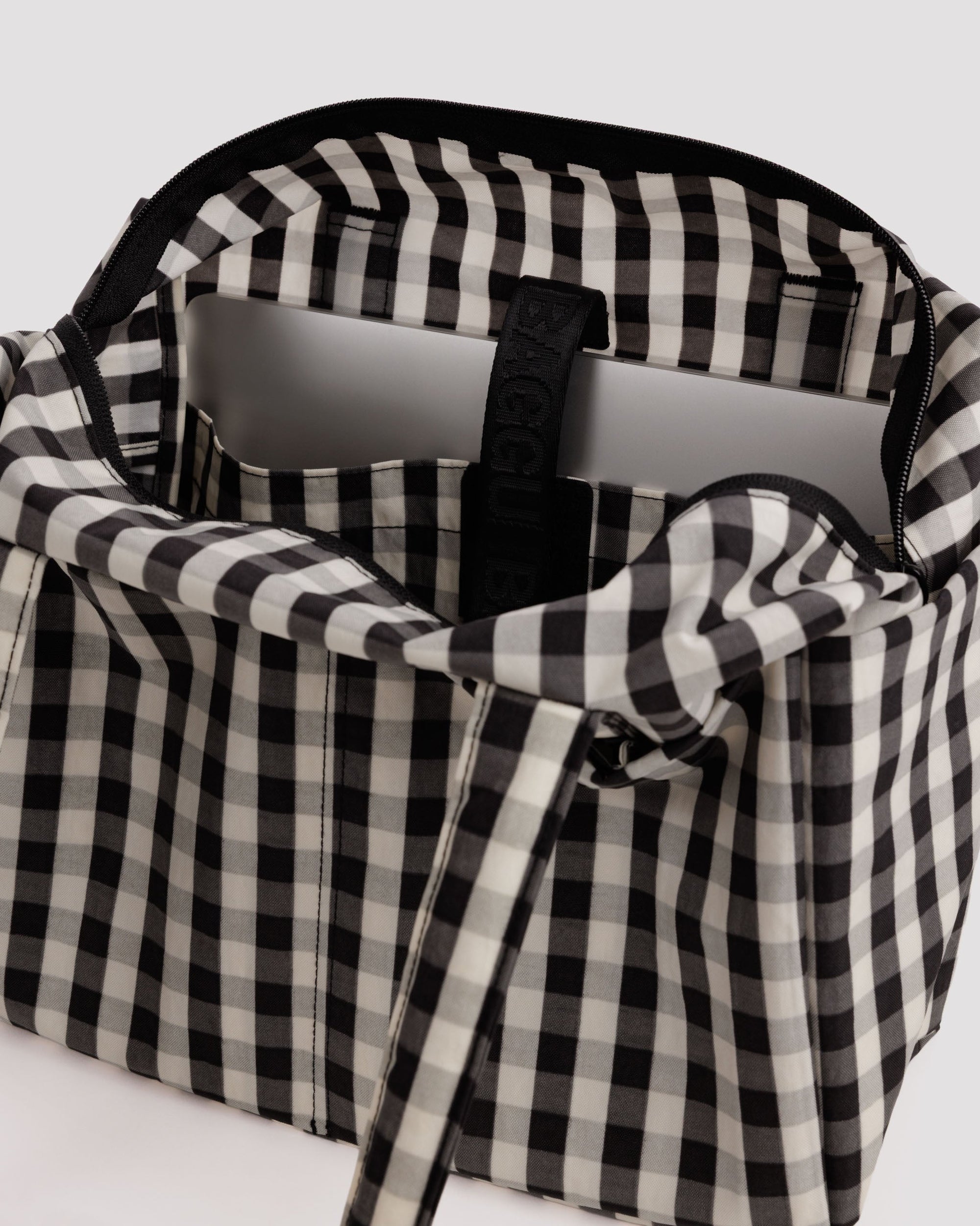 Open Baggu Everyday Cloud Bag in black and cream gingham pattern with laptop inside