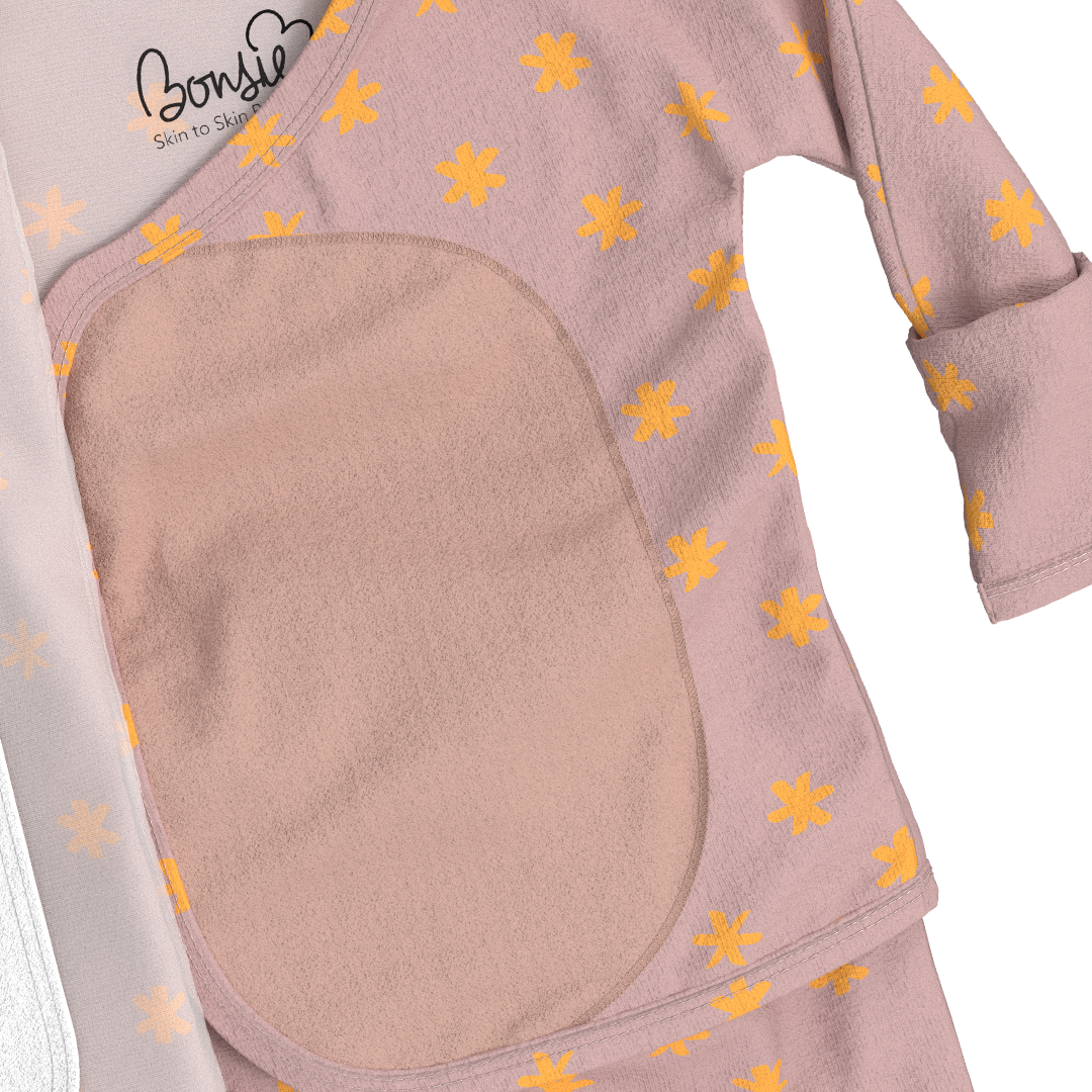 Bonsie Skin to Skin Footie in dusty pink with gold snowflake pattern showing interior fleece panel