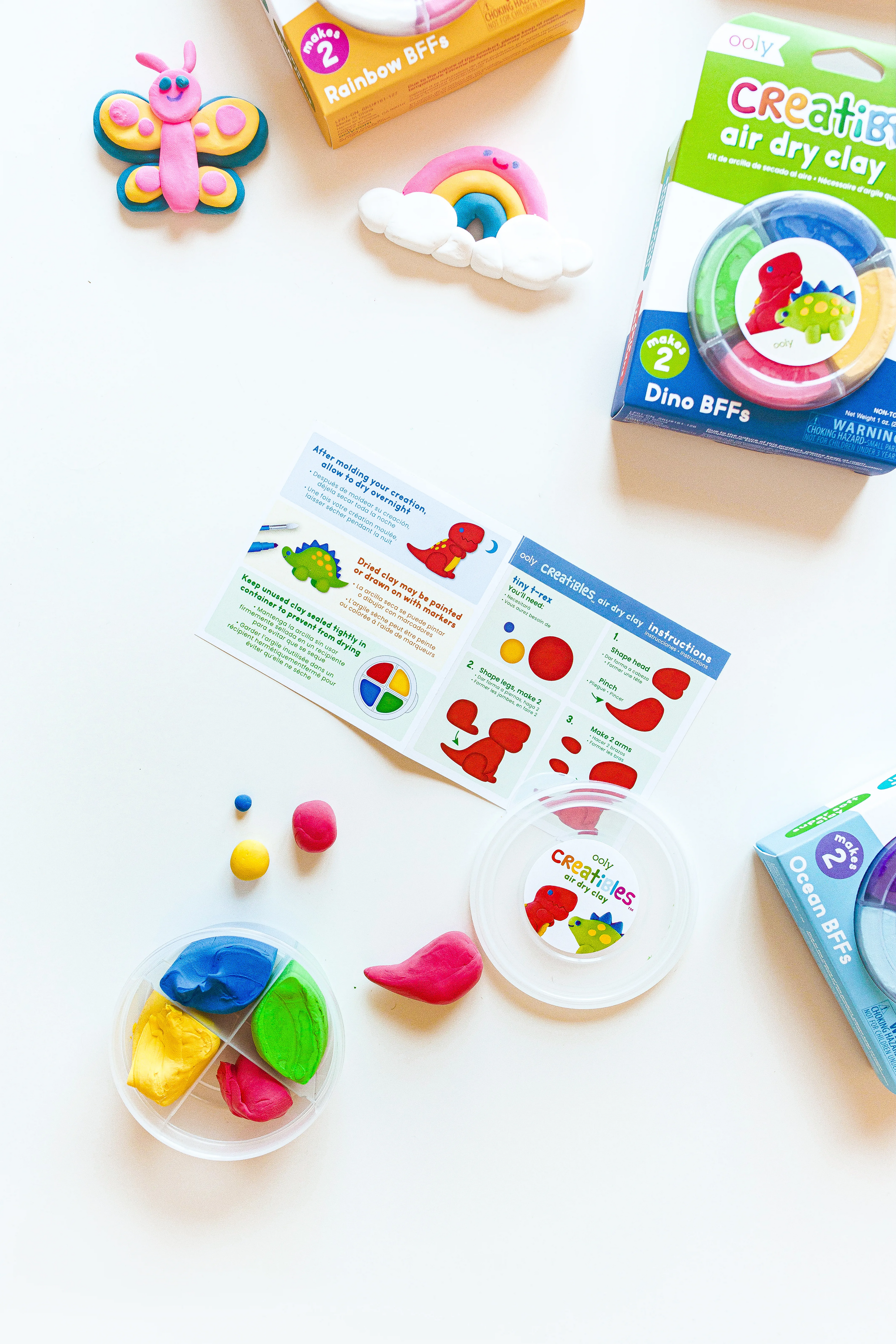 Ooly Creatibles air dry clay kit with colorful clay pieces, instruction sheet, and dinosaur-themed packaging displayed