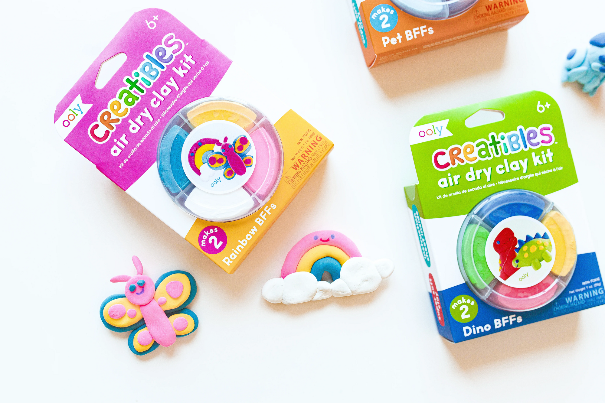 Ooly Creatibles air dry clay kits with rainbow colors and finished clay figures including butterfly and rainbow