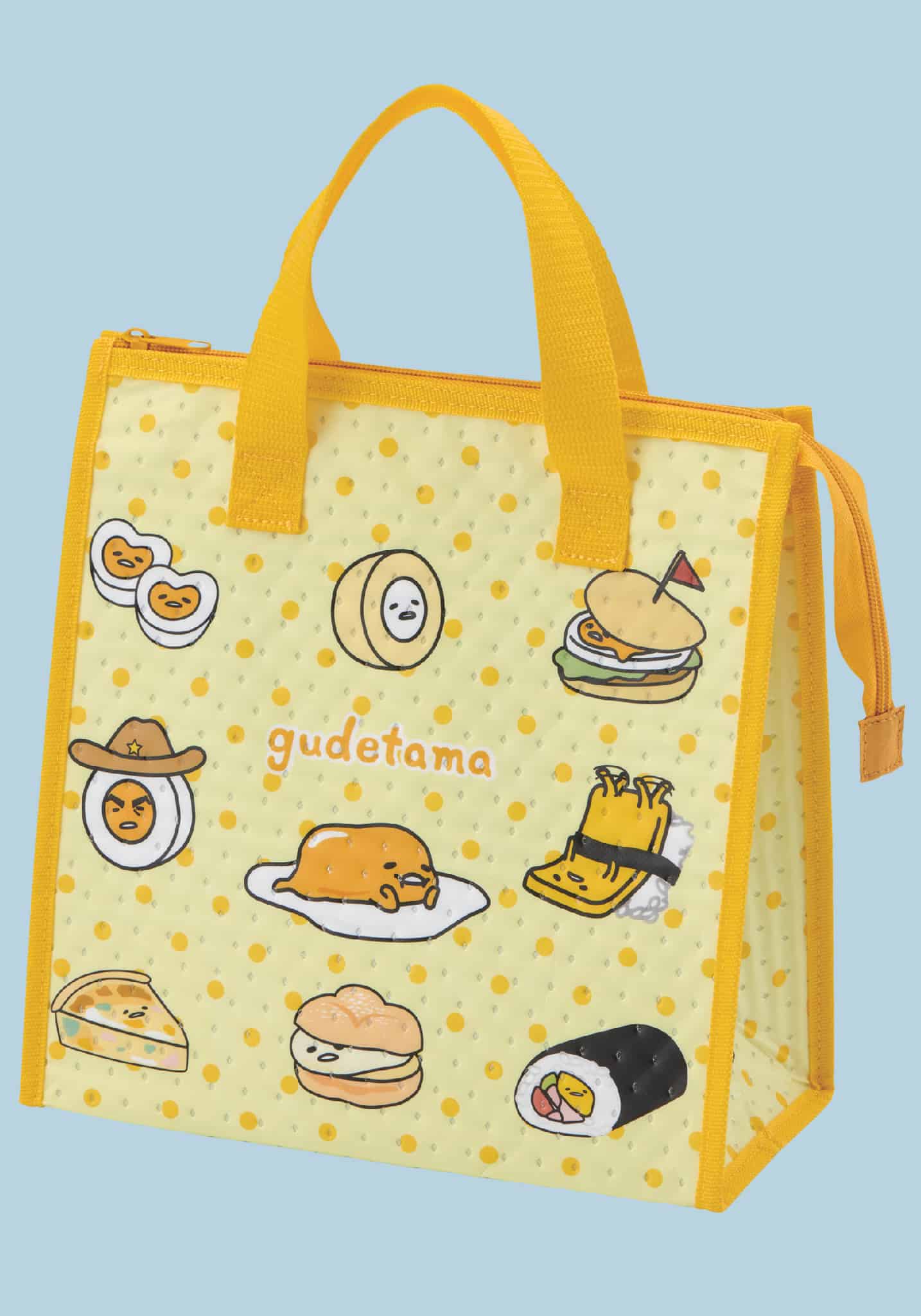 Yellow insulated lunch bag featuring Gudetama egg character designs on polka dot background