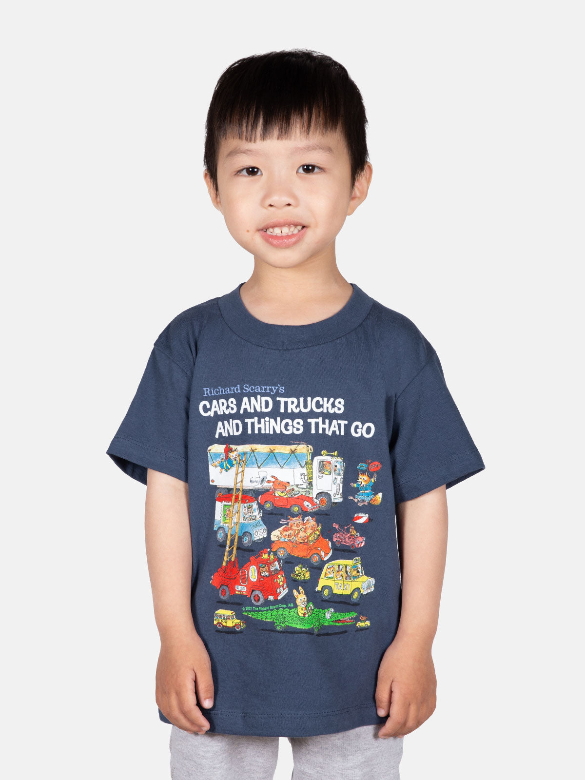 Young child wearing navy blue Richard Scarry Cars and Trucks and Things That Go graphic t-shirt