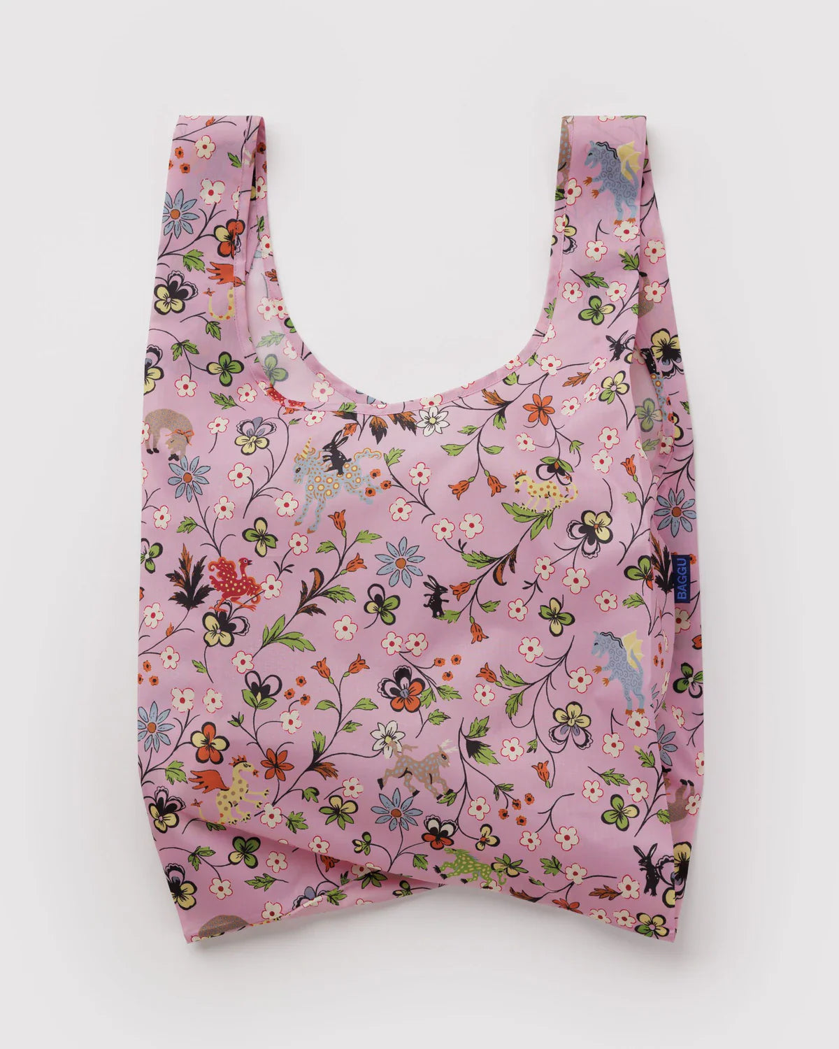Baggu Standard reusable tote bag in pink with whimsical castle creatures and floral print