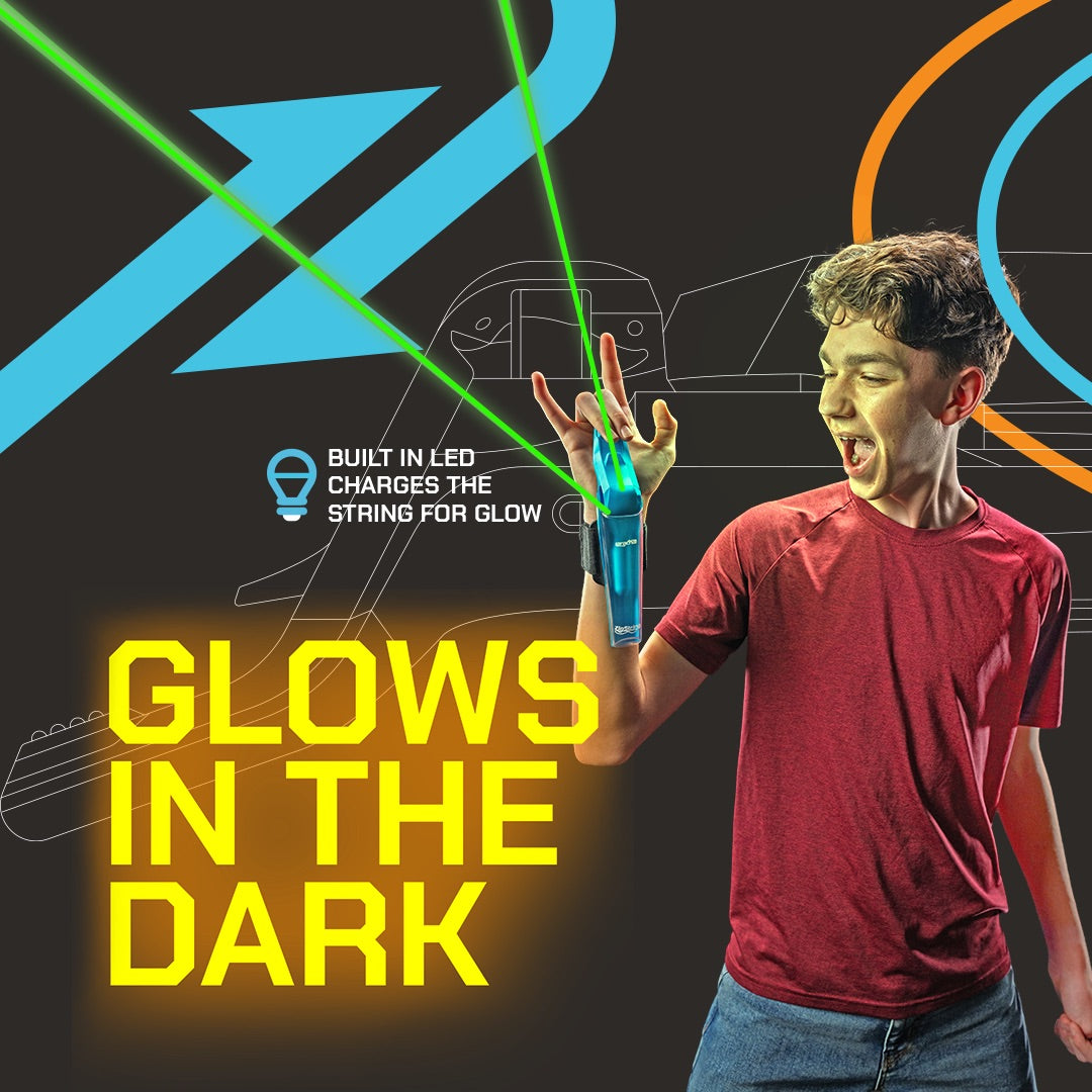 Teen boy demonstrating blue ZipString web shooter toy with glowing green string effect