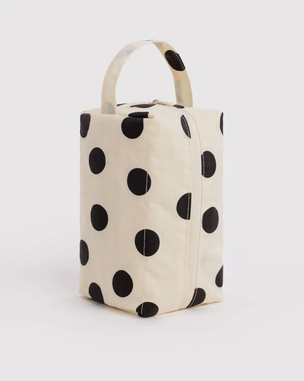 Baggu Dopp Kit in cream canvas with large black polka dots and top handle