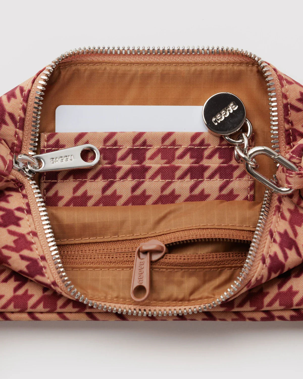 Open Baggu Nylon Pochette in tan houndstooth showing interior card slots and zip pockets