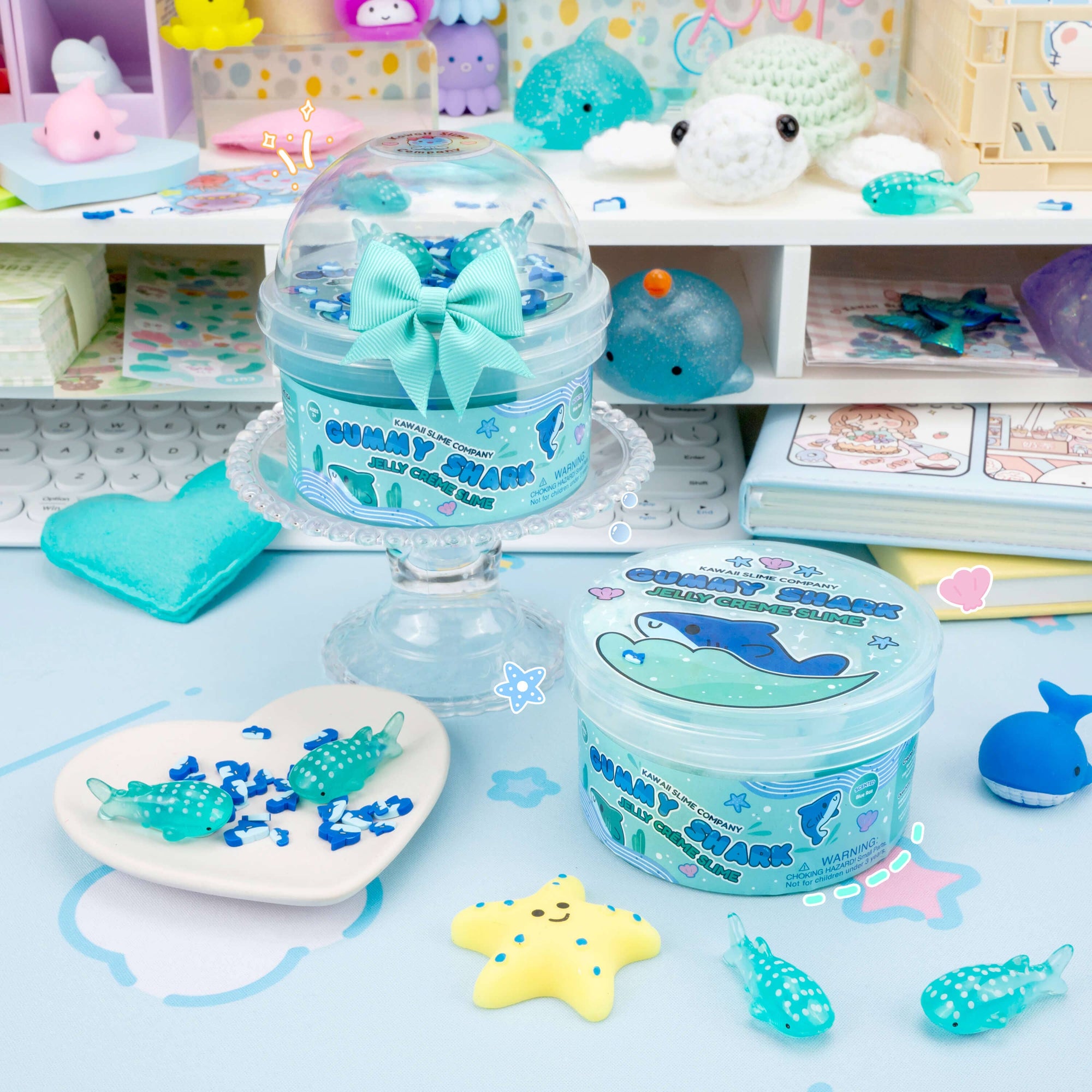 Gummy Shark Jelly Creme Slime in dome and round containers surrounded by kawaii ocean-themed accessories