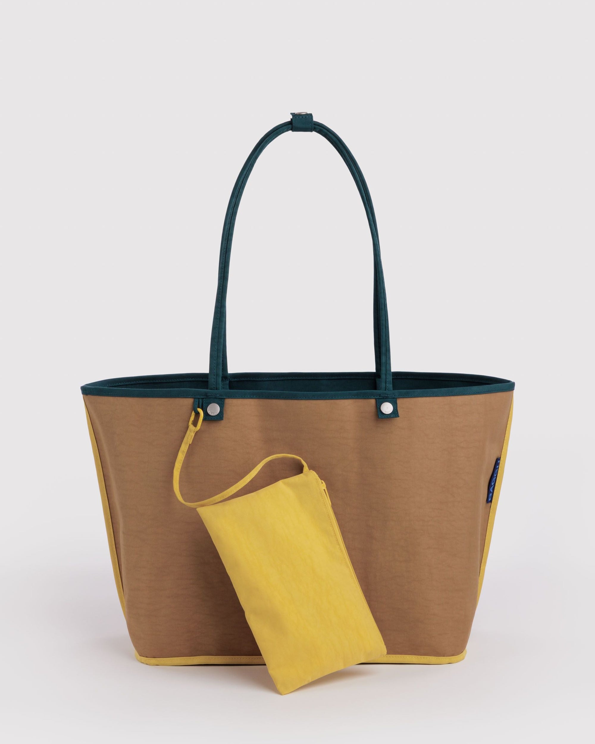 Baggu Large Nylon Reversible Tote in Deep Sea Mix with tan body, teal handles, and yellow zip pouch accessory