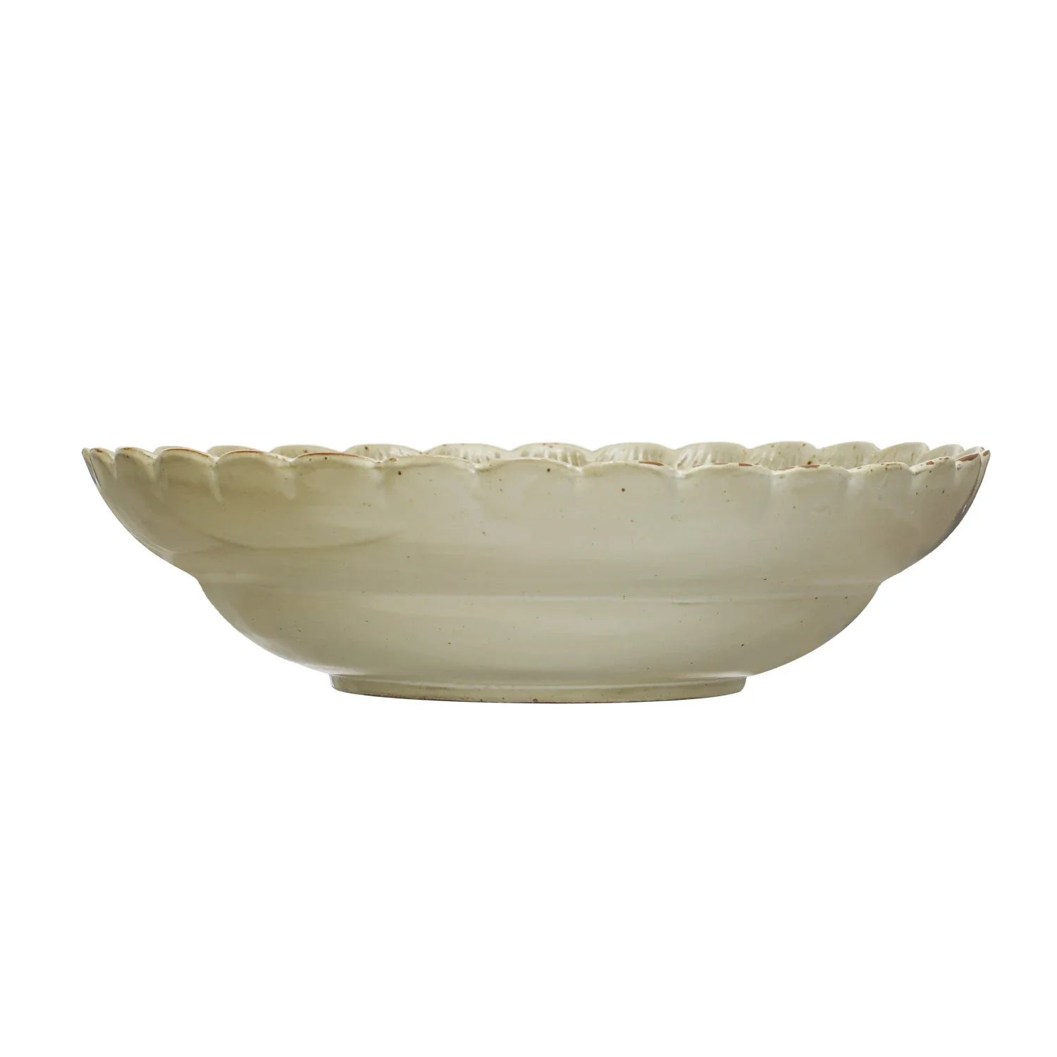 Cream colored stoneware bowl with scalloped decorative rim edge on white background