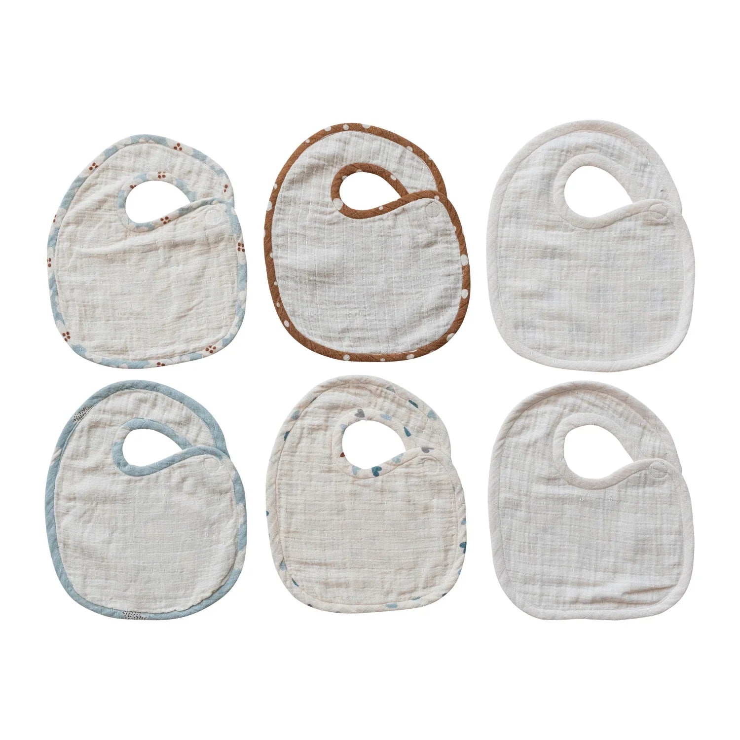 Six cotton double cloth baby bibs in neutral tones with decorative trim patterns