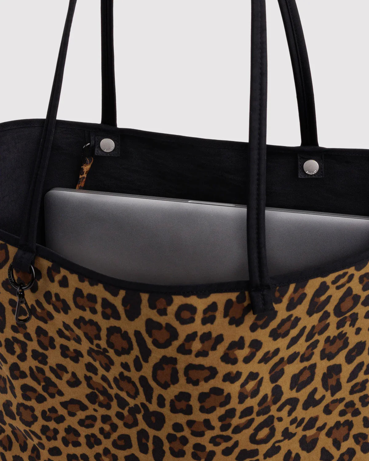 Baggu Large Nylon Reversible Tote in leopard print with laptop inside black interior